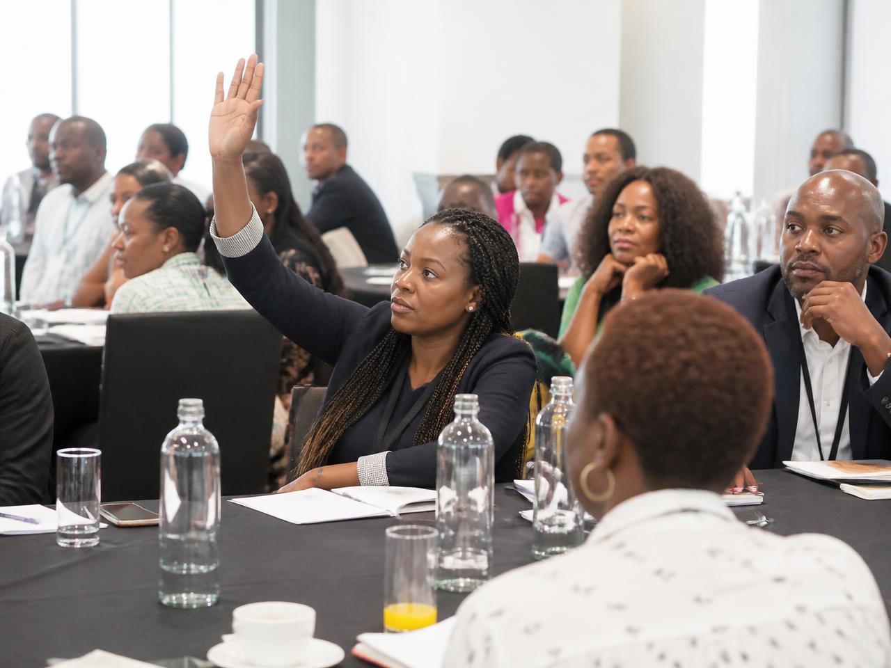 Participants asking questions at a South African business workshop